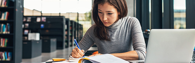 Woman researching Canadian bankruptcy laws at a library 